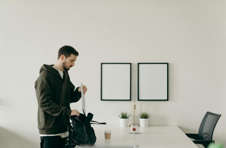 Man in Black Jacket Holding White Paint Brush